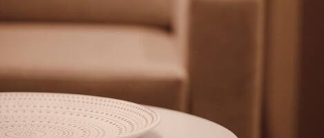 A round table with a white plate and a decorative item.