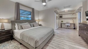 A bedroom with a large bed, a desk, and a ceiling fan. - YOUR private Desert Getaway with FREE Heated Pool! (Phoenix)