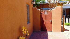 A building entrance with a red gate, a sign reading 'Sunflower Northwest,' and a brick pathway.