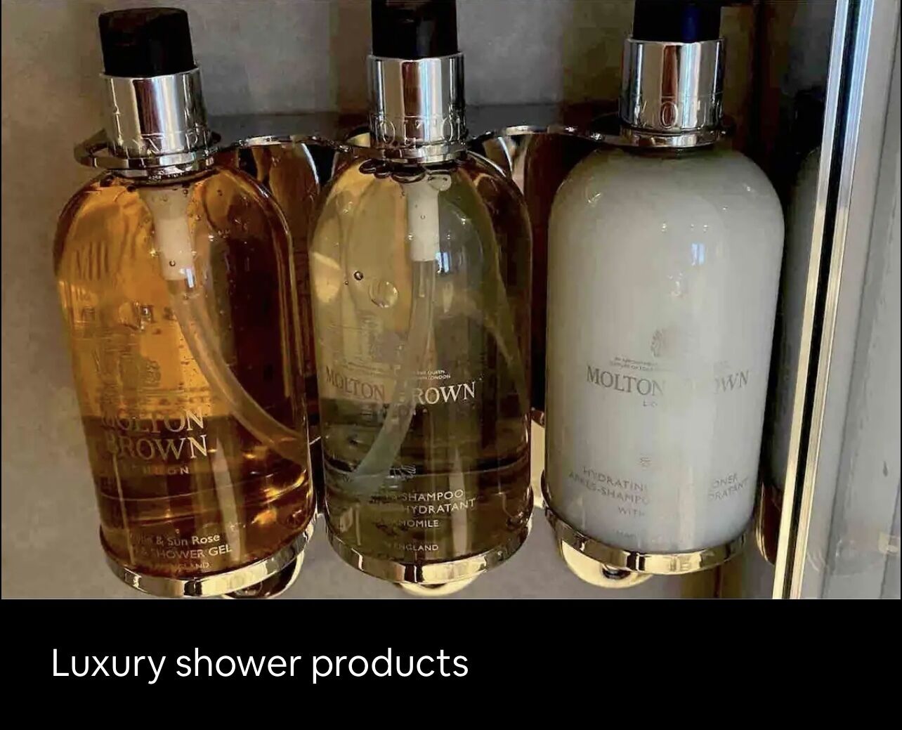 Three bottles of Molton Brown luxury shower products.