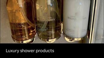 Three bottles of Molton Brown luxury shower products.