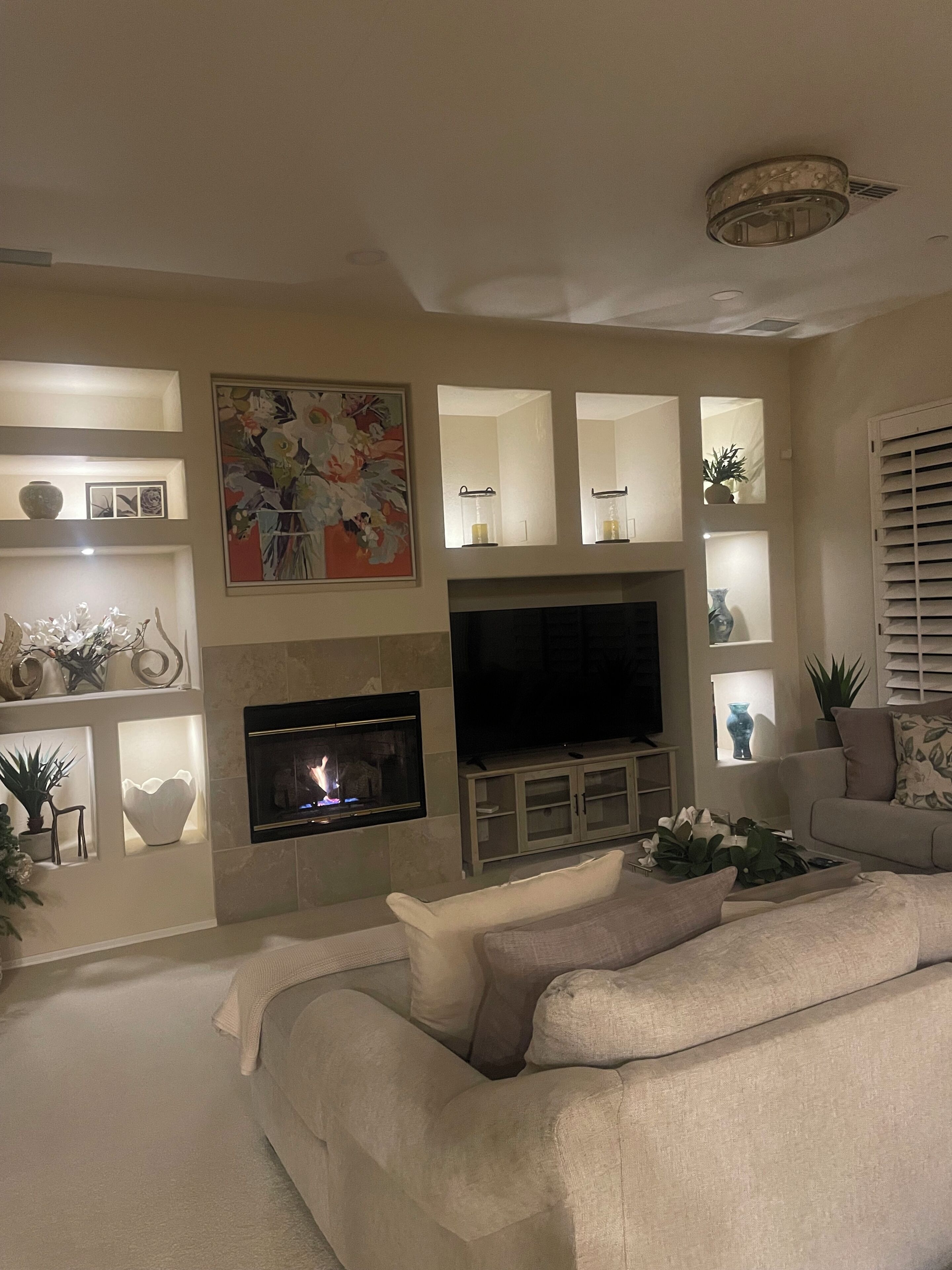 A living room with a fireplace, television, and a sofa.