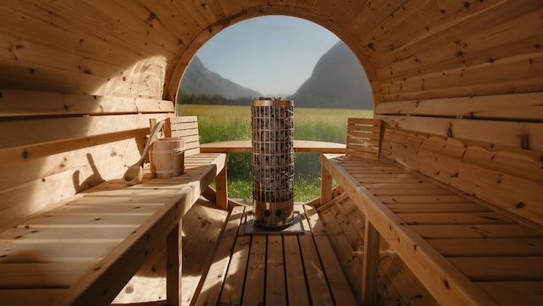 A wooden cabin with a circular opening, wooden benches, a central table, and a view of mountains.