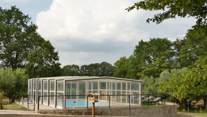 A glass-enclosed building with a pool, surrounded by trees and a grassy area. - Domaine du Venet - Montcony (MONTCONY)