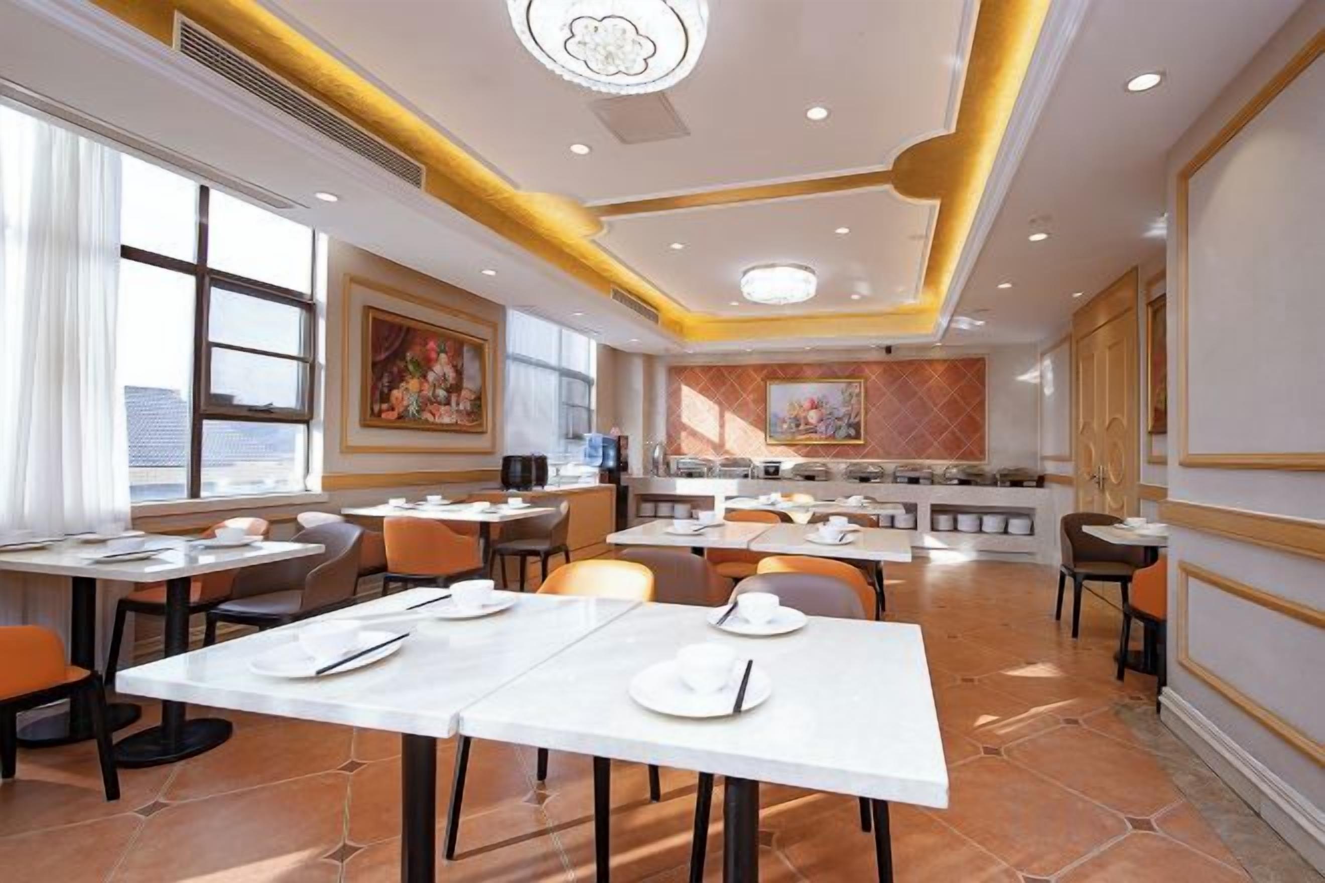 A restaurant with multiple tables, chairs, and a counter area.