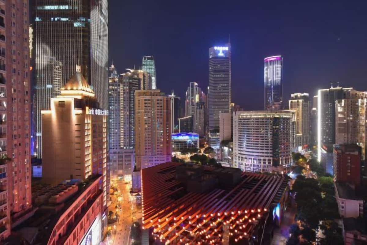 A cityscape with high-rise buildings, one with a distinctive top.