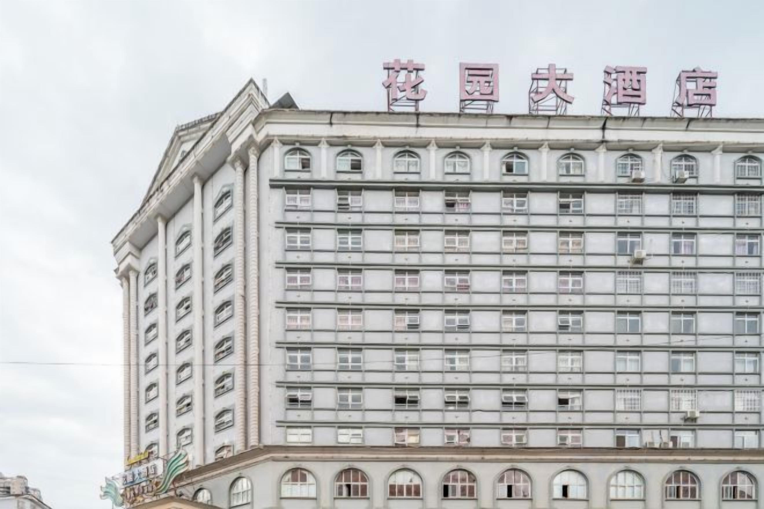 A multi-story hotel building with a row of windows on each floor.