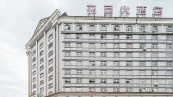 A multi-story hotel building with a row of windows on each floor.