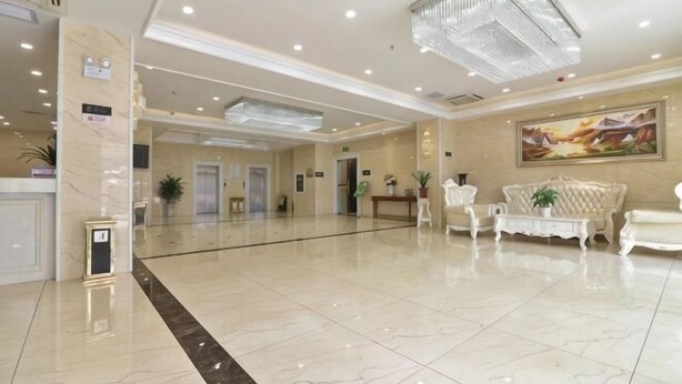 A spacious lobby with a reception desk, seating area, and a large painting on the wall. - Anqing Yingdeli Hotel (Anqing)