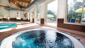 A swimming pool area with a hot tub, large windows, and a view of the outdoors. - Club Les Alpes Dazur (La Salle-les-Alpes)