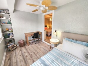 A bedroom with a bed, desk, chair, and shelves. - NEW Townhouse 3 Min Walk to Beach, 11 pools, backyard (Panama City Beach)