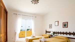 A hotel room with two beds, a balcony with curtains, and a city view. - Wonderful private villa for 10 people with private pool, A/C, WIFI, TV, terrace and pets allowed (Benissa)