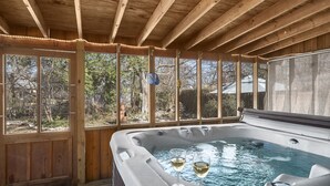 A wooden deck with a hot tub and two glasses of wine. - Hein House | Hot Tub | Shared Pool (Fredericksburg)