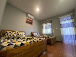 Relax in this stylish room with a large bed, comfortable seating area, and a window offering a view of the outside.