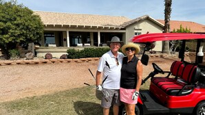 A golf cart with a red canopy parked in front of a house with a tiled roof and a stone facade. - PC Furn Golf Course Home. 36 PB courts for Nat's Nov `24 incl cart, hk 'ing util (Goodyear)
