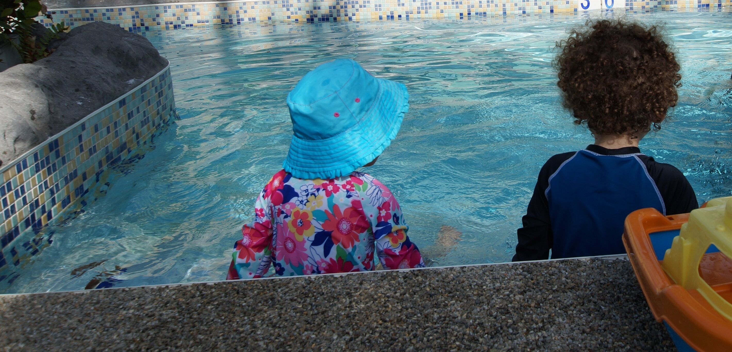 A pool with tiled edges and a pebble bottom.