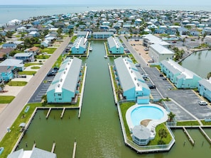 A coastal hotel with a marina, multiple swimming pools, and a view of the ocean.