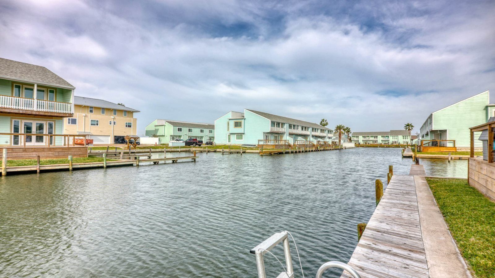 A waterfront property with multiple buildings, docks, and a wooden walkway.
