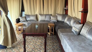 A cozy living area with a large sofa, a wooden coffee table, and patterned cushions. - Casa Morisca Classic (Sidi Ifni)
