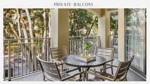 Enjoy dining or socializing on the balcony with a round table and four chairs.