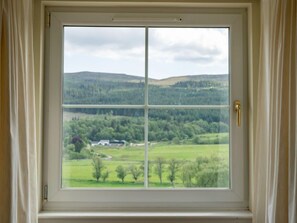 Enjoy a serene view of rolling hills and lush green fields from the comfort of your room.
