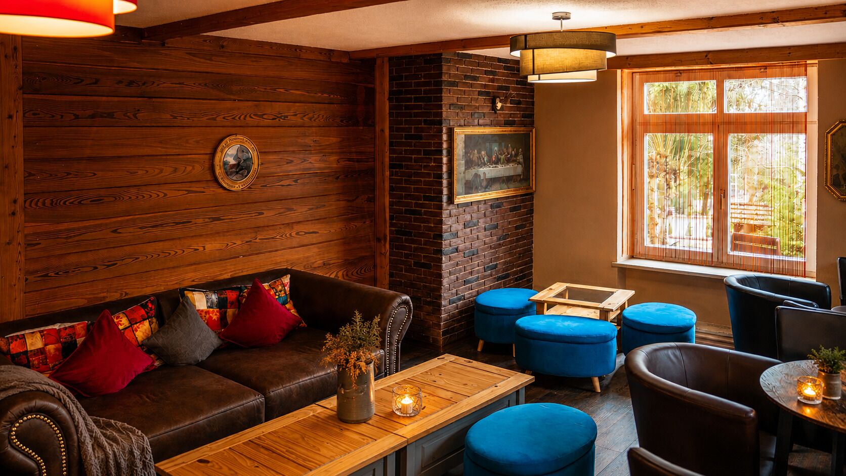 A cozy interior with a leather sofa, blue ottomans, and a wooden coffee table.