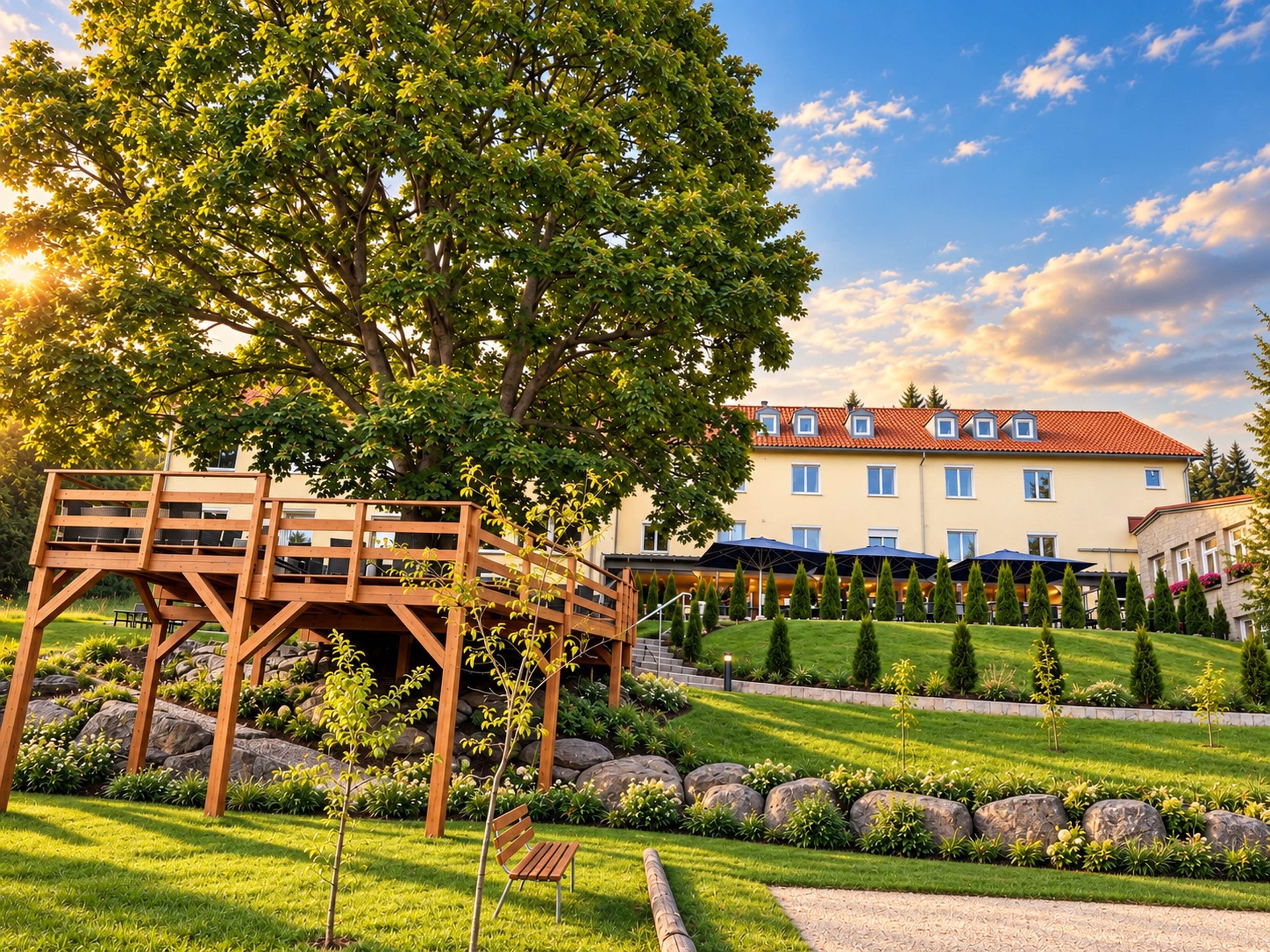 A wooden deck with a bench, a building with a red-tiled roof, and a well-maintained lawn with a stone pathway.
