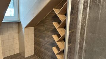 A modern staircase with wooden steps and a tiled floor.