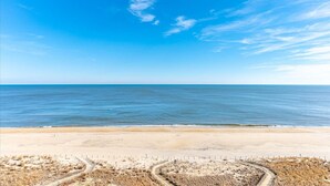 A beach with a clear sky and calm sea. - Quay-3 Bedroom Ocean Front Condo (Ocean City)