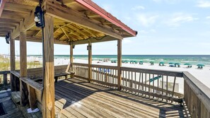 A wooden deck with a view of the beach and ocean. - 110 El Matador 2 Bedroom Condo by RedAwning (Fort Walton Beach)