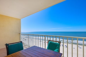 A balcony with a view of the beach.