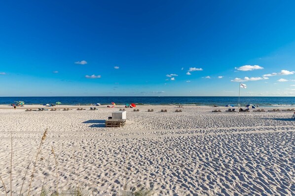 Relax on the beach with comfortable sun loungers and shaded areas under umbrellas.