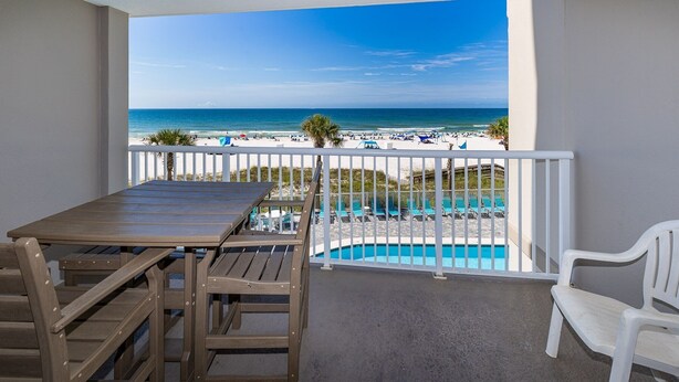 A balcony with a view of the beach and pool. - Tradewinds 203 1 Bedroom Condo (Orange Beach)