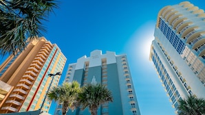 A tall hotel with balconies and a sign reading "Island Royale."