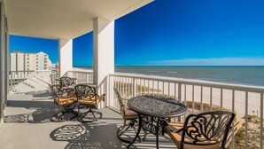 A balcony with a view of the beach, featuring outdoor furniture and a railing. - Island Tower 601 3 Bedroom Condo (Gulf Shores)
