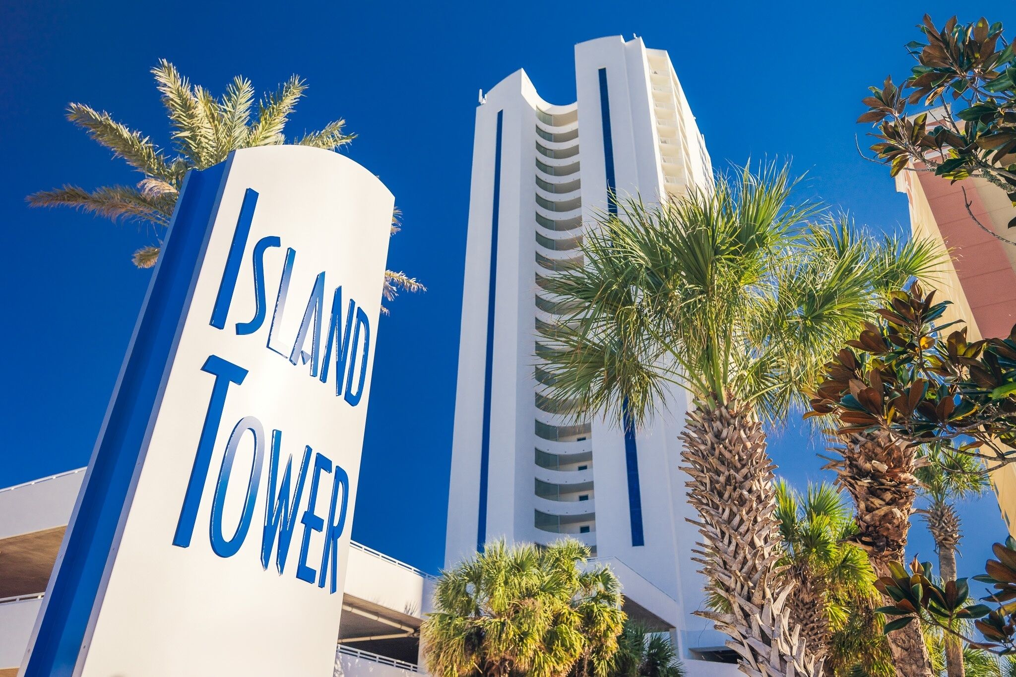 A tall building with a sign that reads "Island Tower."