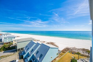 A beachfront property with a clear view of the ocean and sandy beach. - Tradewinds 706 2 Bedroom Condo (Orange Beach)