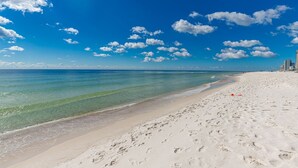 A beach with clear blue water, white sand, and footprints. - Seaside Beach & Racquet 4407 3 Bedroom Condo (Orange Beach)
