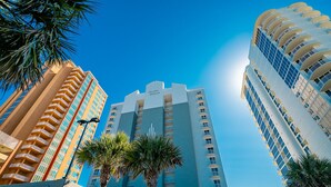 A tall hotel with balconies and a sign reading "Island Royale."