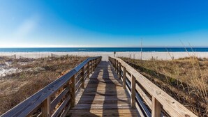 A wooden boardwalk leading to a beach with clear skies. - Royal Palms 1207 1 Bedroom Condo (Gulf Shores)