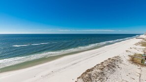 A wide beach with a clear sky and calm sea. - Royal Palms 1207 1 Bedroom Condo (Gulf Shores)