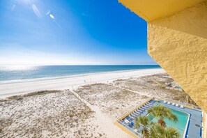 A beach view with a swimming pool and lounge chairs. - Driftwood Towers 5a 2 Bedroom Condo (Gulf Shores)