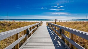 A wooden boardwalk leading to a beach with a clear blue sky. - Sea Chase 505c 3 Bedroom Condo (Orange Beach)
