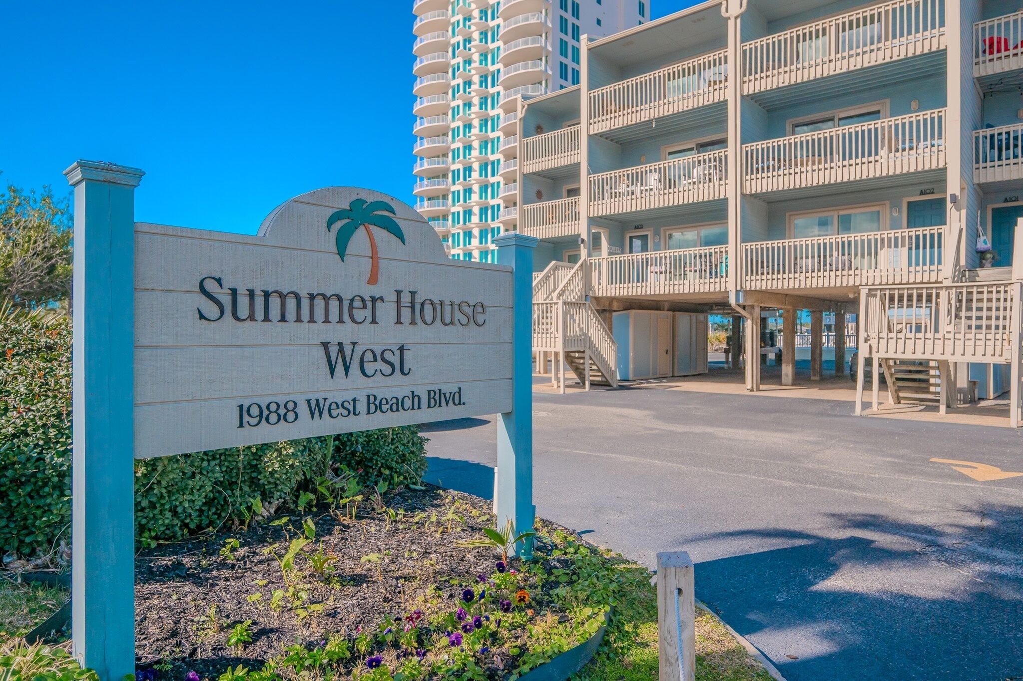 A sign for 'Summer House West' at 1988 West Beach Blvd.