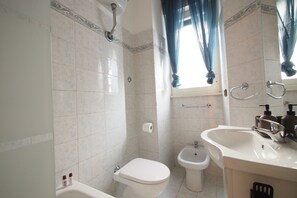 A bathroom with a toilet, bidet, and sink. - A Quiet & Cozy Colosseum (Roma)
