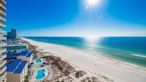 A beachfront hotel with multiple swimming pools, a beach, and ocean views.