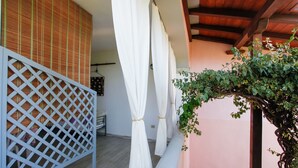 A corridor with a white lattice partition, a wooden ceiling, and a wall with a bamboo-like pattern. - Holiday Home "mirtagru Bilo Mare 2" with Sea View, Private Terrace and Wi-Fi (Budoni)