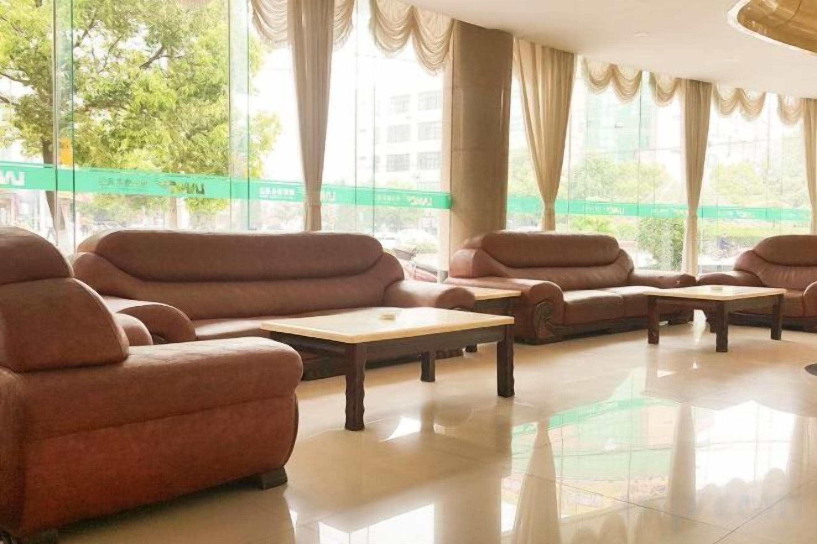 A hotel lobby with sofas and tables arranged for seating.