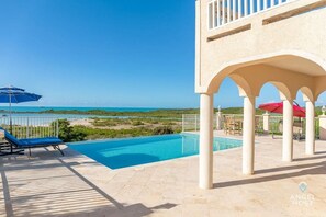 Outdoor pool, an infinity pool, pool loungers