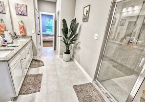 A bathroom with a shower, a sink, and a mirror. - Tidal Walk * New 5BR Bethany Beach House (Millville)